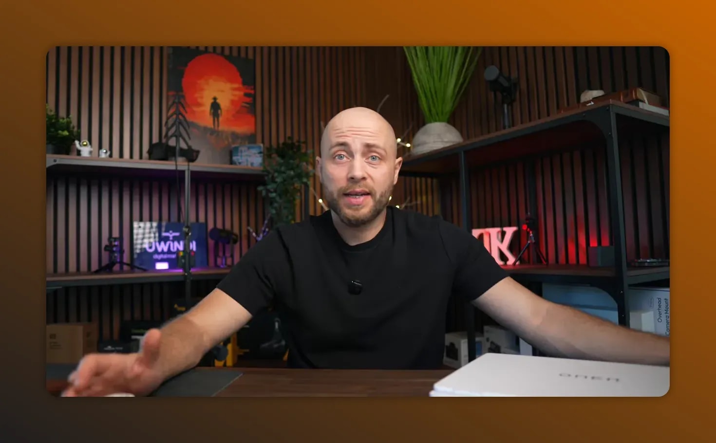 Presenter on camera comparing MacBook Pro vs HP Omen noise during daily use