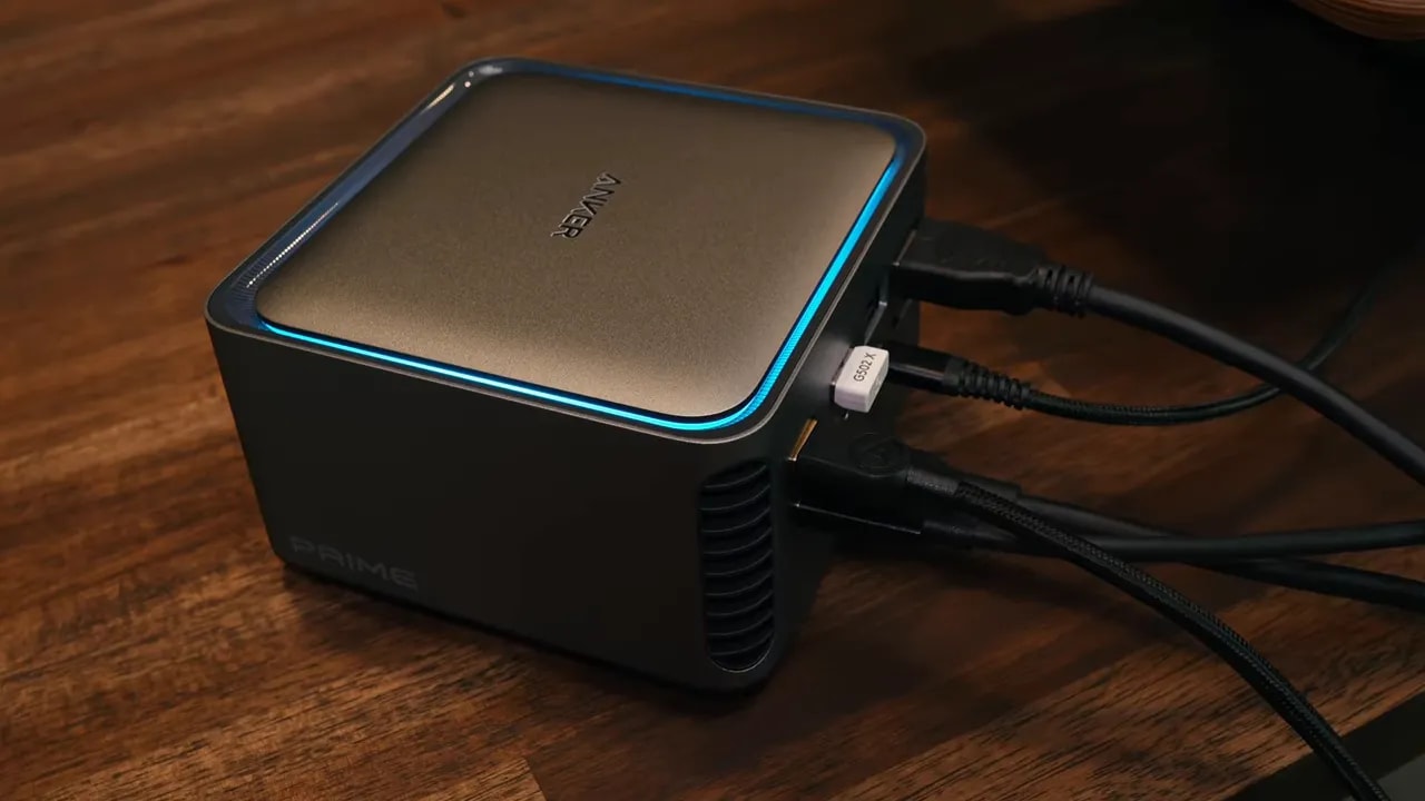 Anker Prime dock on a wooden desk with a silver top, illuminated border, side ventilation, and connected cables