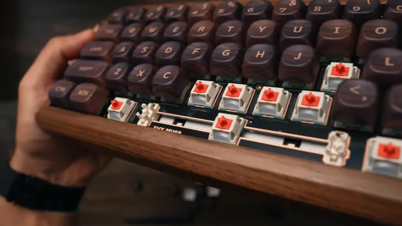 Keyboard with lower keycaps removed showing red switches and stabilizers