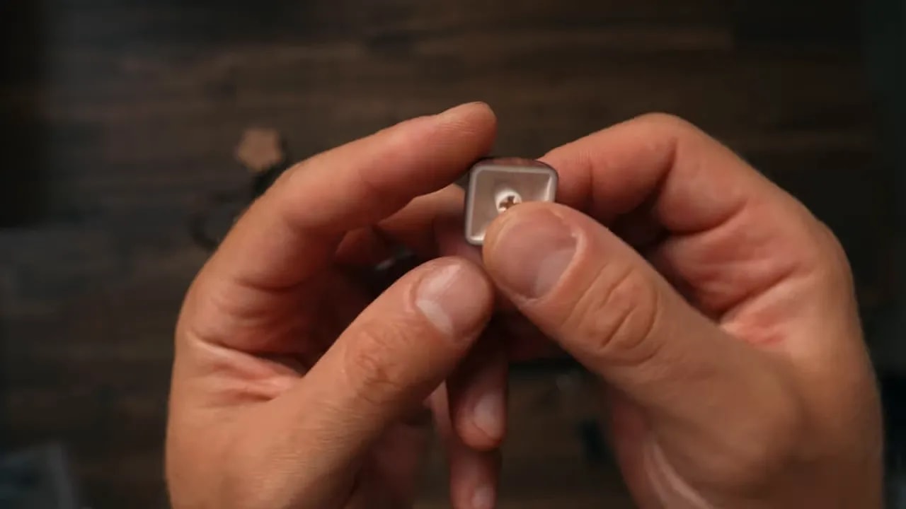 Close view of the underside stem of a rounded dark keycap