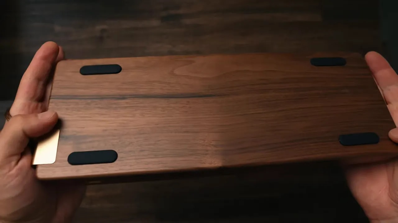 Walnut keyboard underside with four large black rubber pads