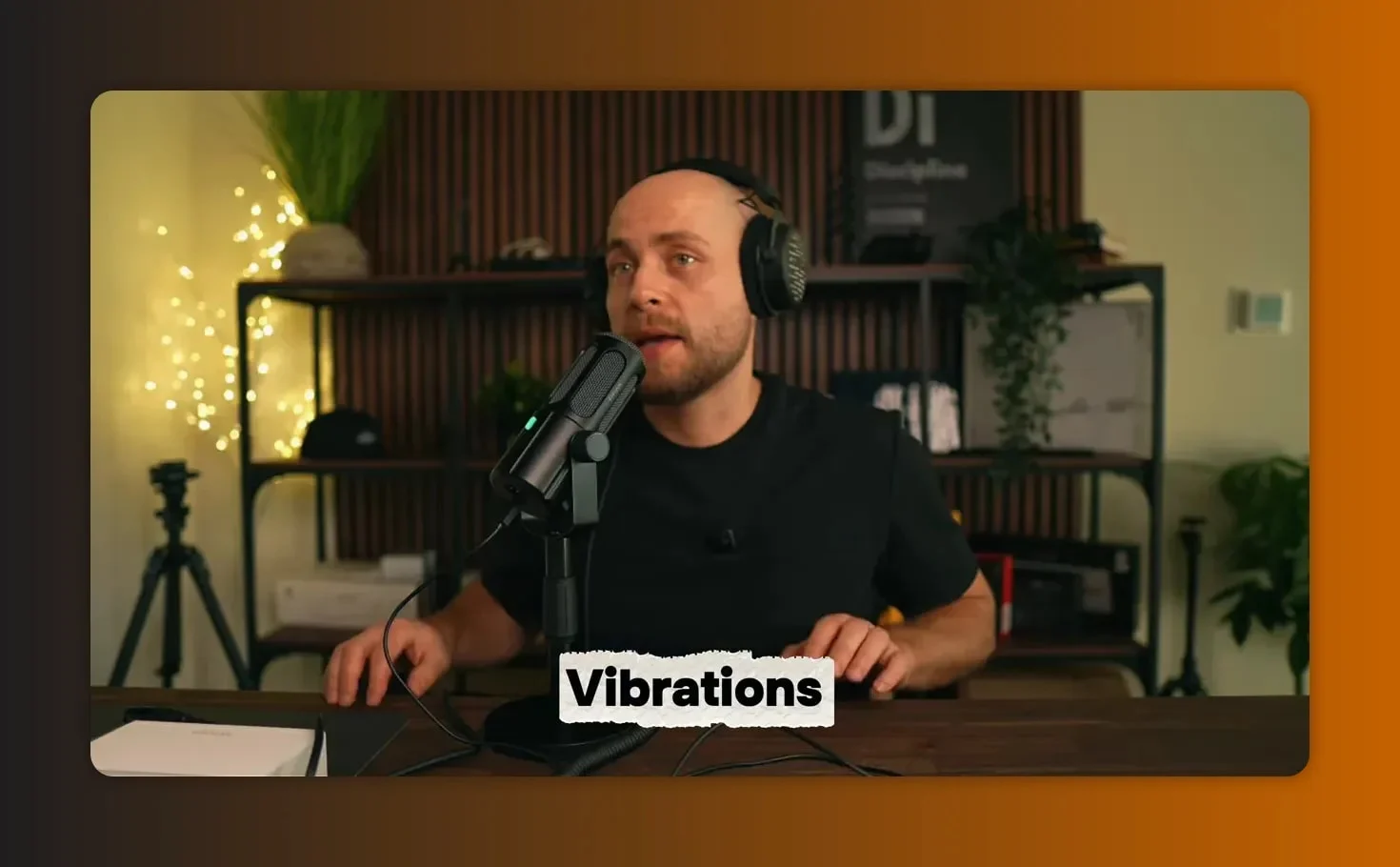Fifine Tank 6 on a desk with the host placing hands on the desk to demonstrate vibrations transferring to the microphone.