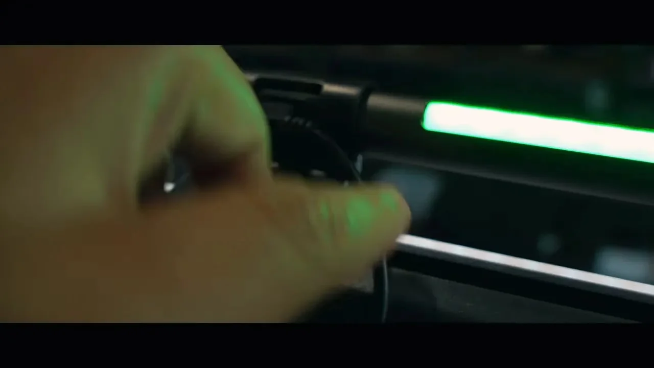 Power cable plugged into the side of RGB monitor light bar behind monitor