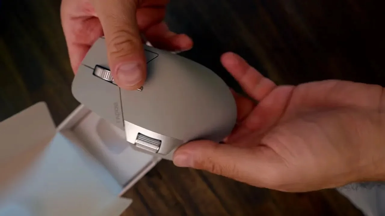 Close-up of hands inspecting the Rapoo MT760 Pro mouse body