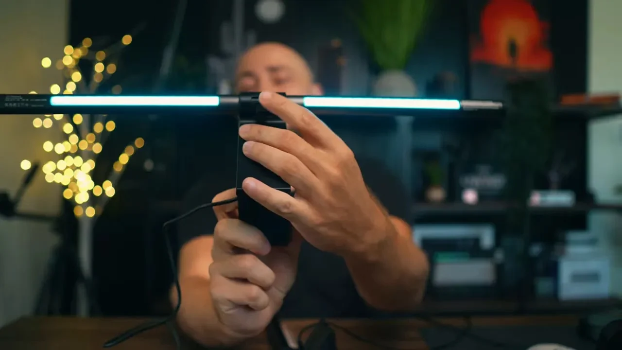 Illuminated Quntis light bar attached to large black monitor clip
