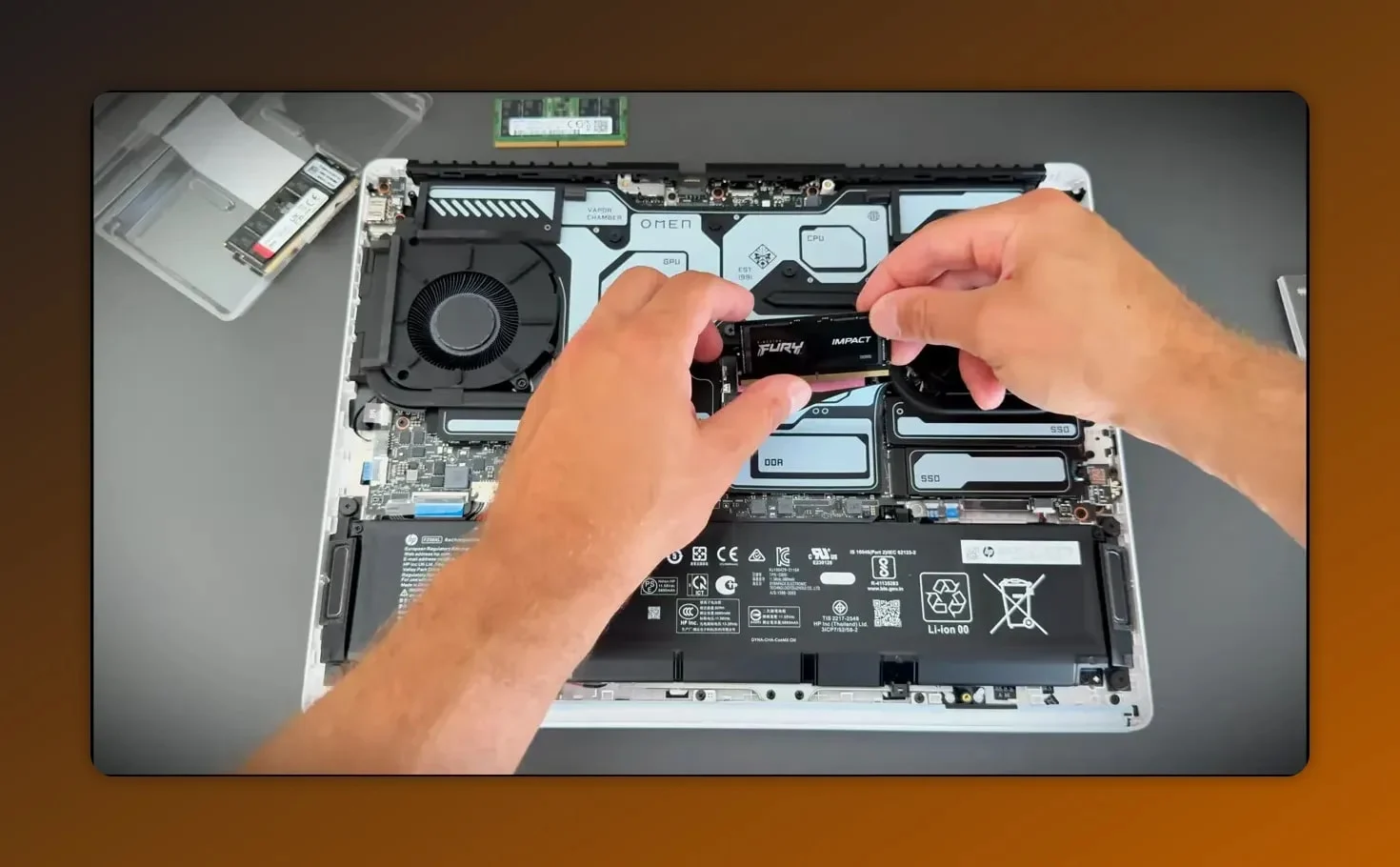 Kingston FURY Impact DDR5 SO-DIMM being inserted into the SO-DIMM slot of an HP Omen Max 16