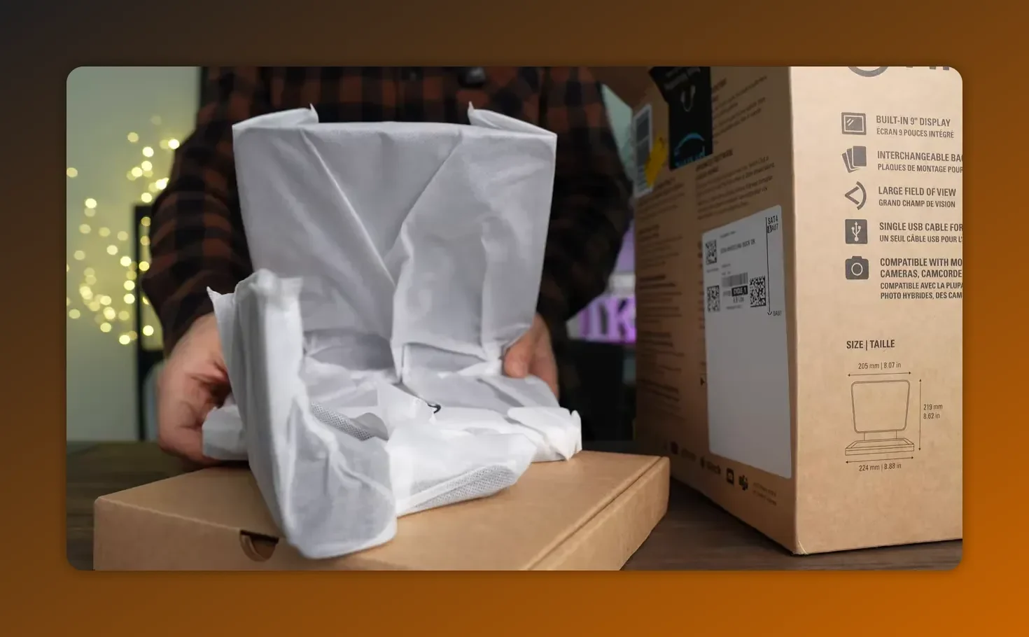 Prompter component wrapped in protective cloth sitting on the inner box with the main retail box nearby