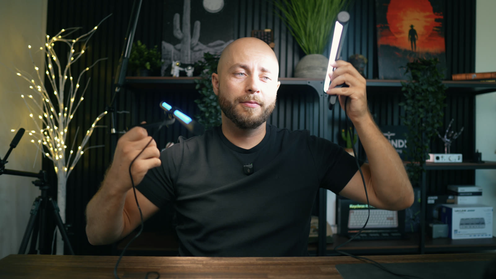 Two monitor light bars side by side, one in each hand